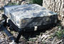 The Ultimate Seat by Sportsman Comfort Products ( one leg extended, leaning against a tree ). 